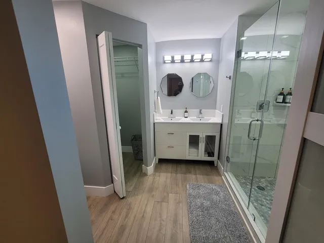a bathroom with a mirror a sink and vanity