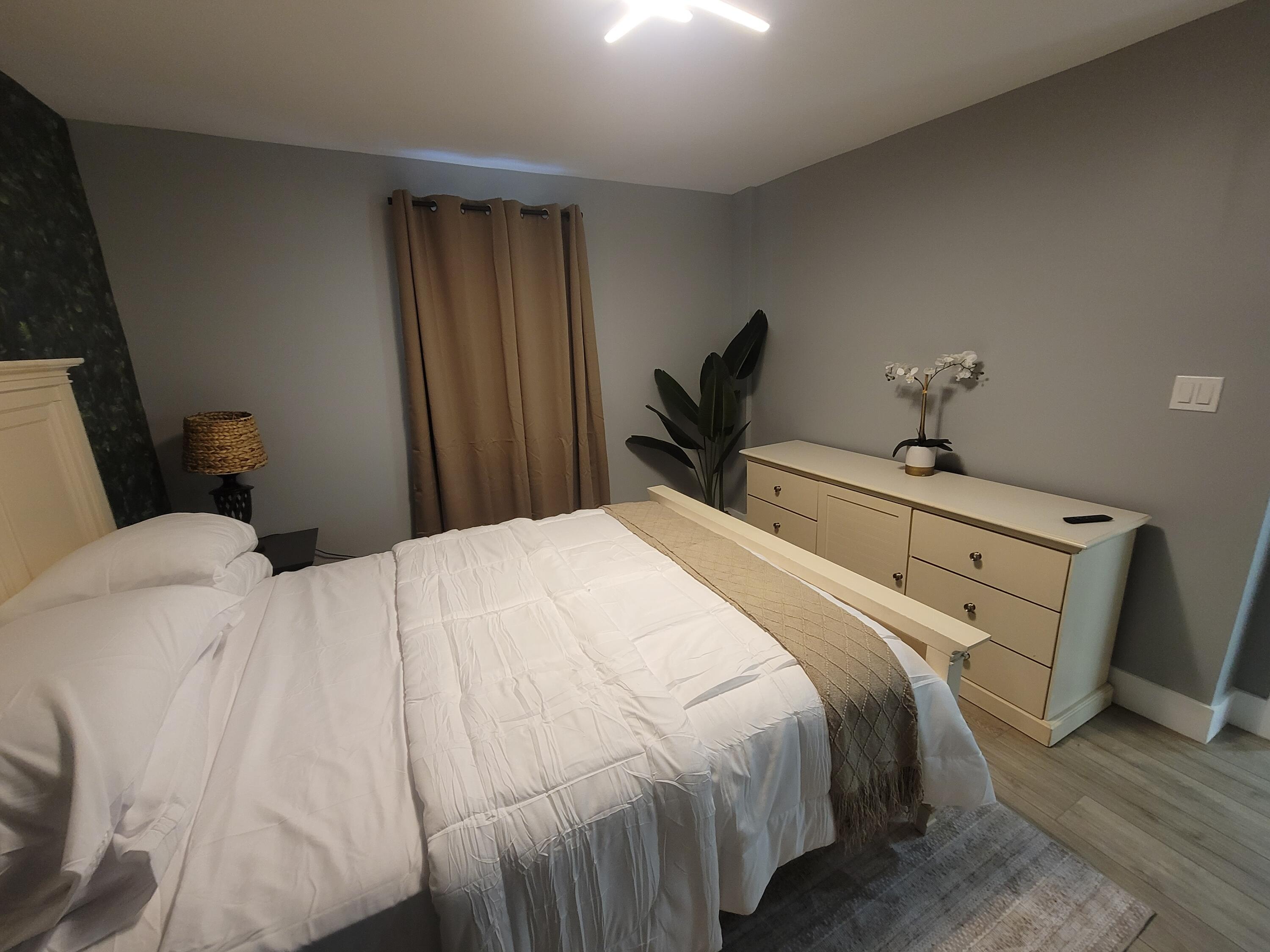 106 East Chandler Road Cloud Lake, FL 33406 - Photo 10 of 10 a bedroom with a bed and a mirror