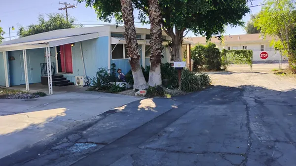a view of a house with basketball court