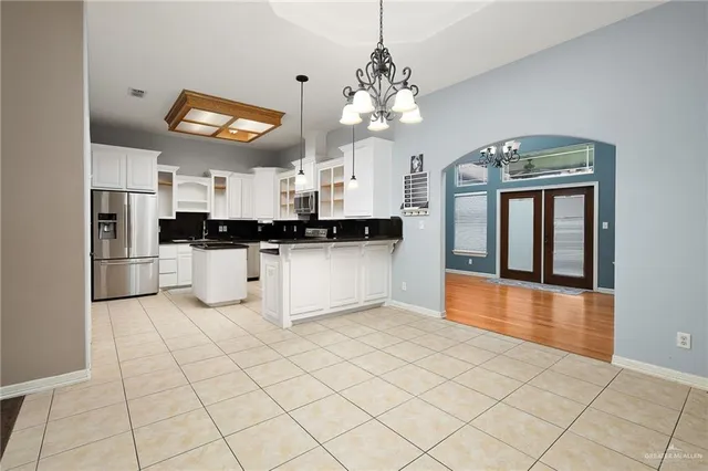 a view of a livingroom with a chandelier fan and a window