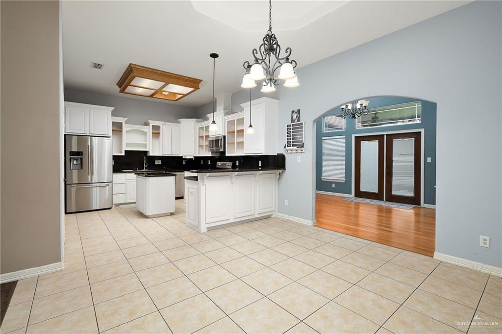 1236 Chloe Rae Circle Weslaco, TX 78599 - Photo 11 of 30 a kitchen with stainless steel appliances granite countertop a refrigerator a stove top oven and a sink with granite countertops