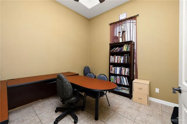 a view of a workspace with furniture and a window