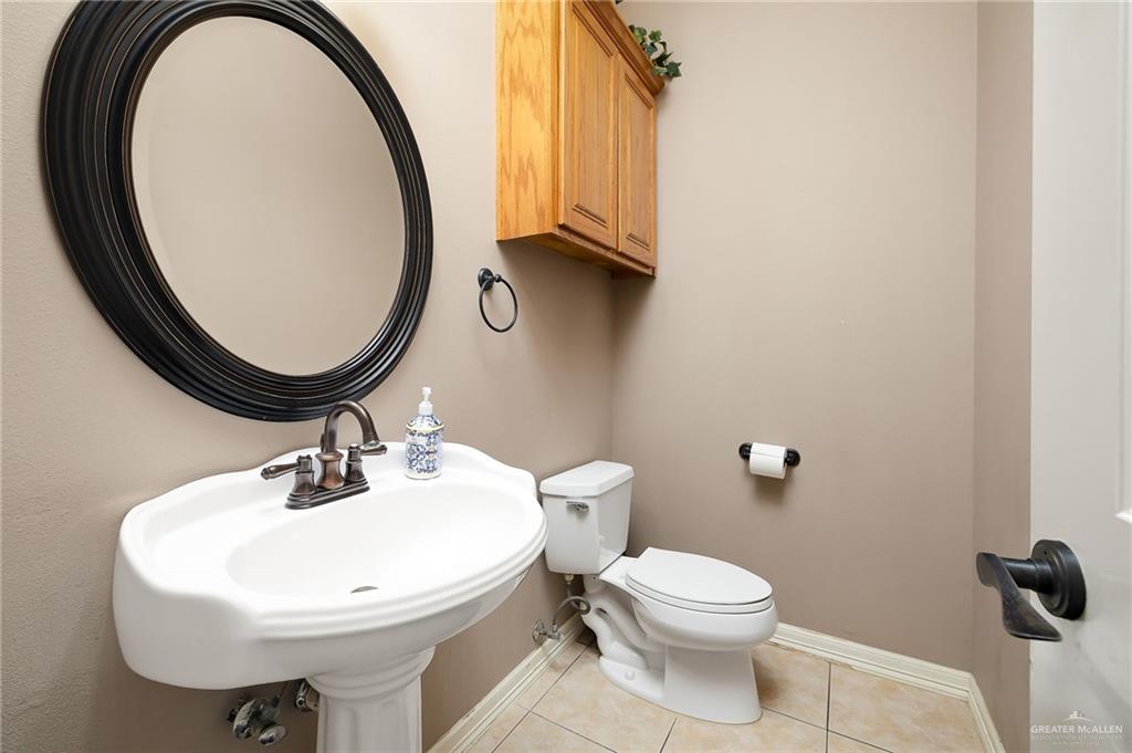 1236 Chloe Rae Circle Weslaco, TX 78599 - Photo 14 of 30 a bathroom with a sink a toilet and a mirror