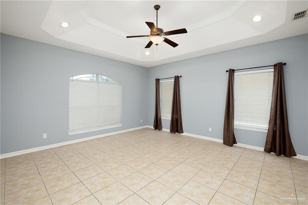 1236 Chloe Rae Circle Weslaco, TX 78599 - Photo 20 of 30 a view of a livingroom with a ceiling fan & hardwood floor