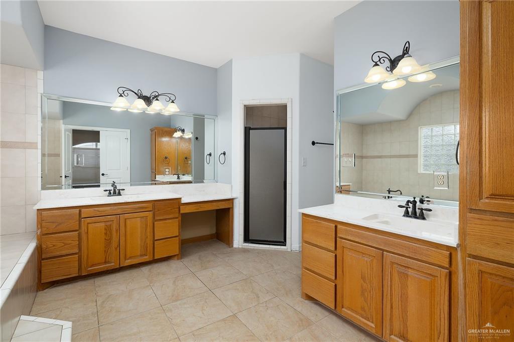 1236 Chloe Rae Circle Weslaco, TX 78599 - Photo 21 of 30 a large bathroom with a double vanity sink mirror and bathtub