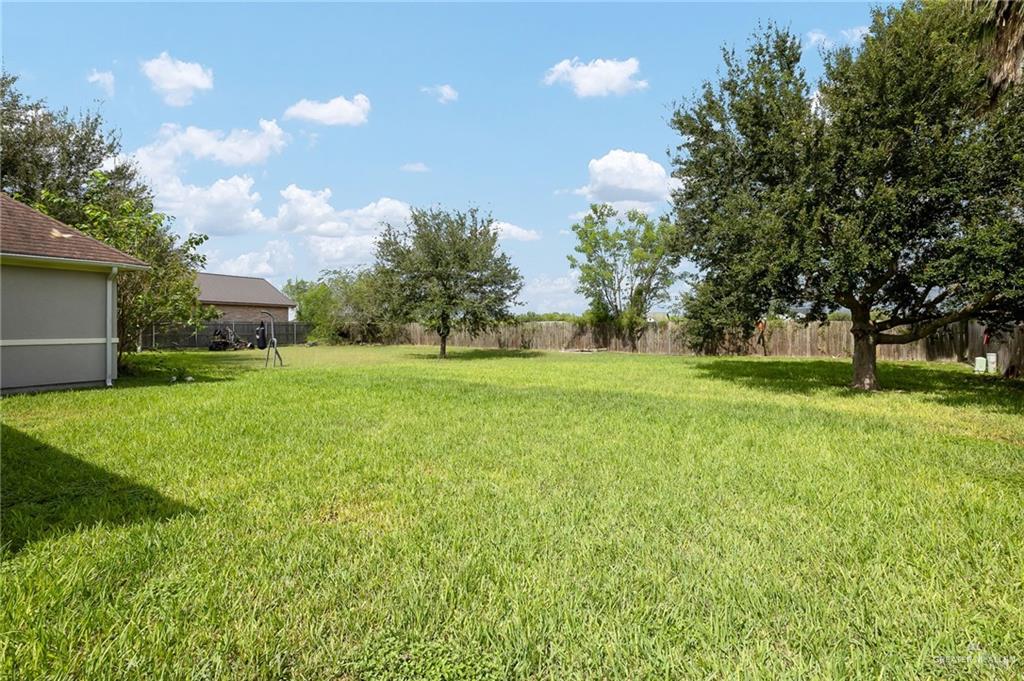 1236 Chloe Rae Circle Weslaco, TX 78599 - Photo 25 of 30 a backyard of a house with lots of green space and fountain