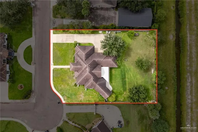 a front view of a house with a garden and plants