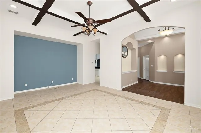 a view of a room with a ceiling fan and a window