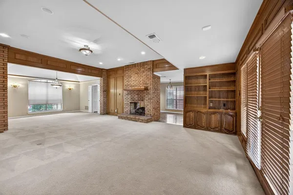 a view of an empty room with a fireplace