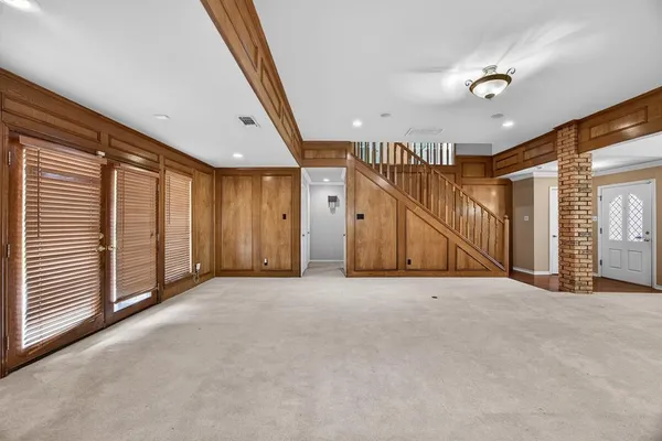 a view of an empty room with stairs