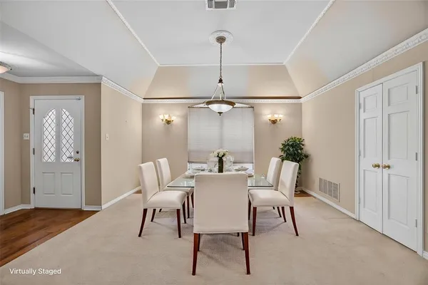 a dining room with furniture and window