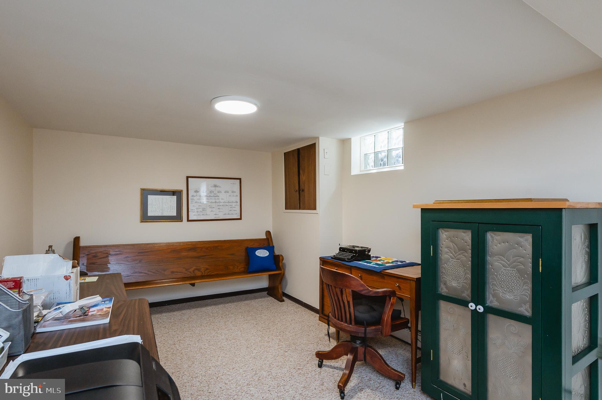 8337 Analee Avenue Rosedale, MD 21237 - Photo 36 of 48 a view of a workspace with furniture and a ceiling fan