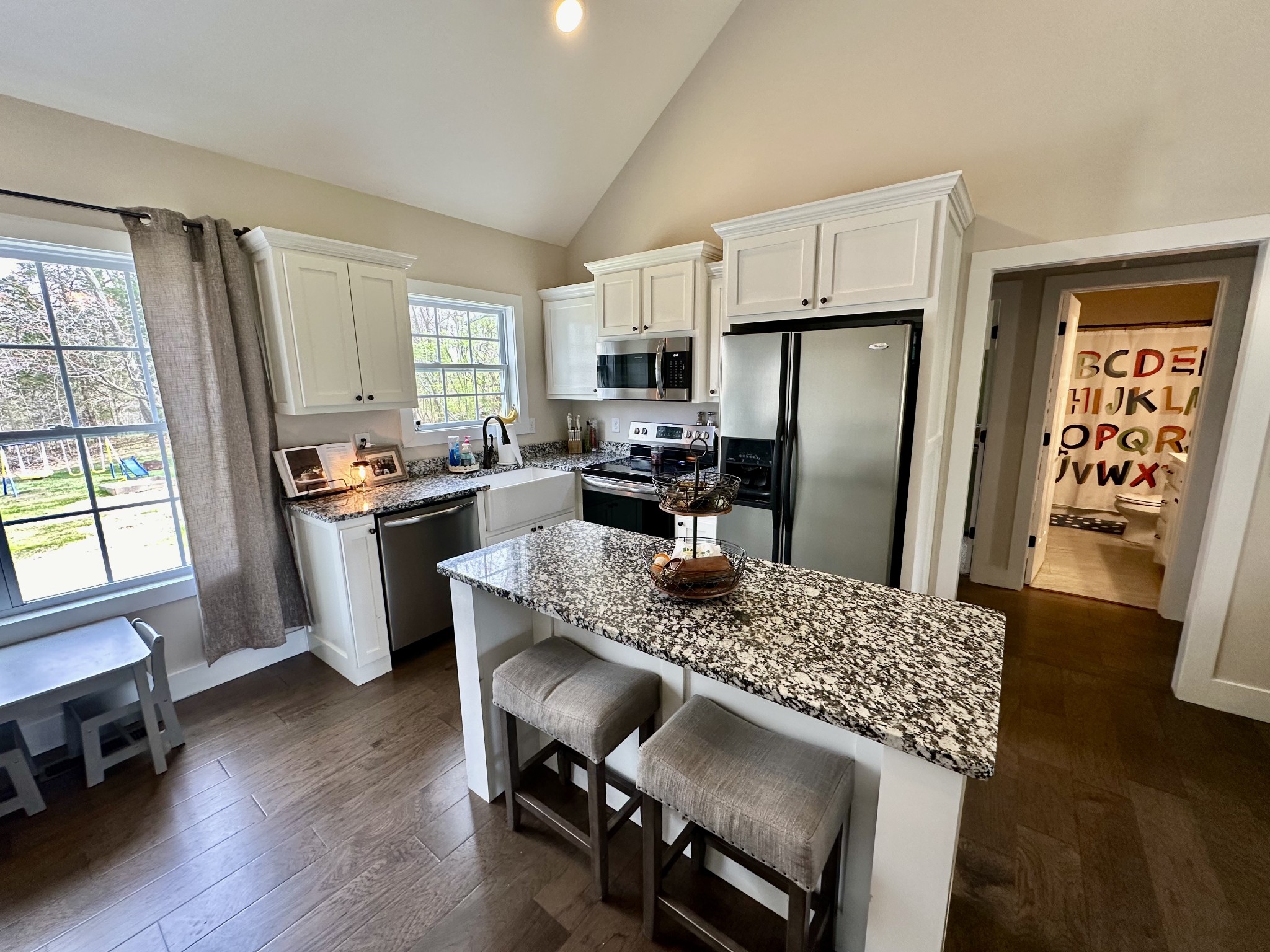 194 Mitchell Road Portland, TN 37148 - Photo 5 of 17 a kitchen with stainless steel appliances granite countertop a stove a refrigerator a sink a dining table and chairs