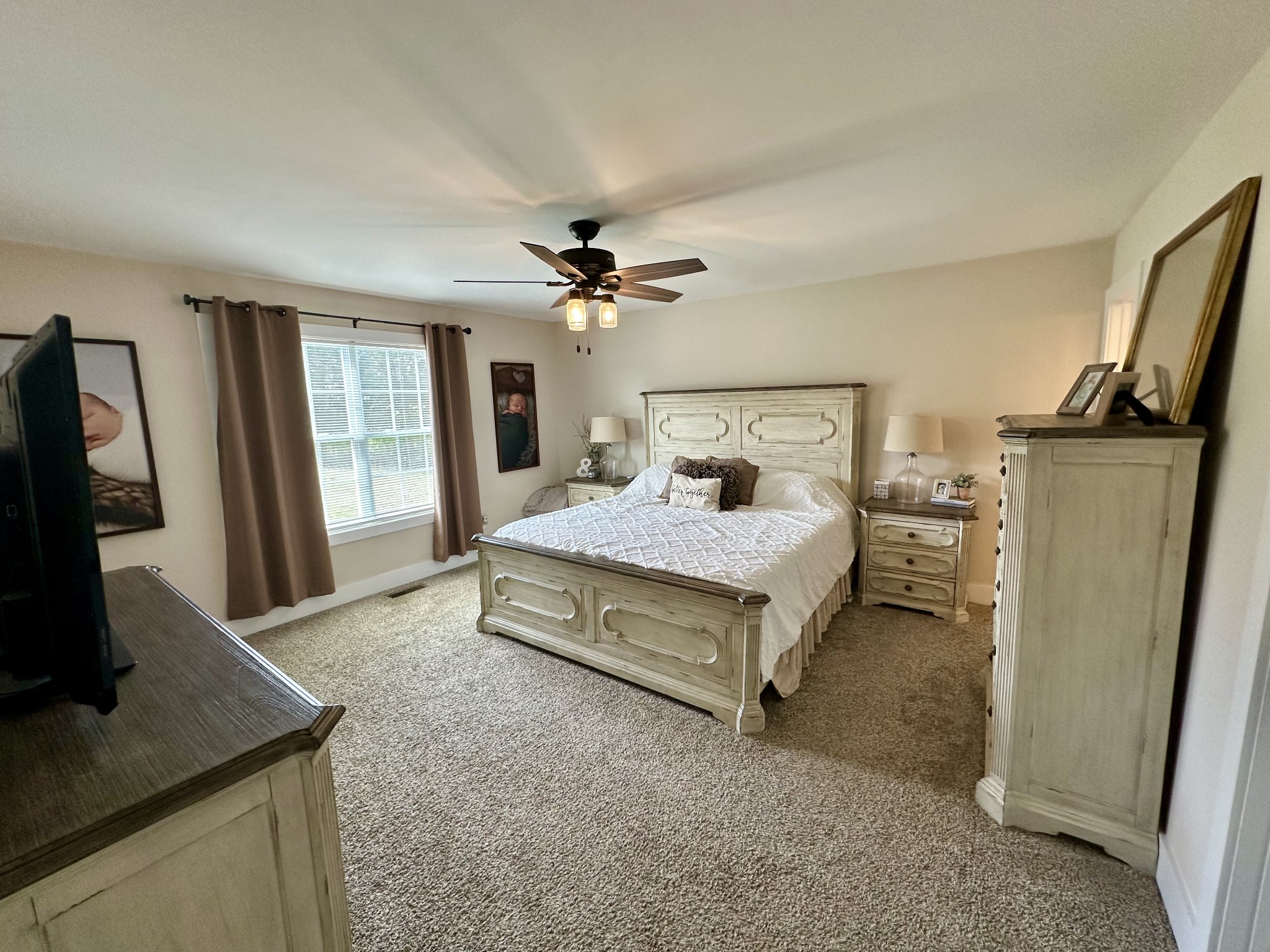 194 Mitchell Road Portland, TN 37148 - Photo 8 of 17 a spacious bedroom with a bed a window and flat screen tv