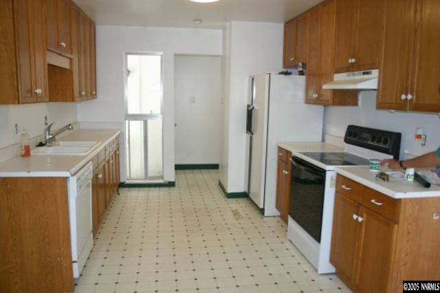 1389 Tioga Way Reno, NV 89503 - Photo 3 of 4 a kitchen with a sink a stove and a refrigerator