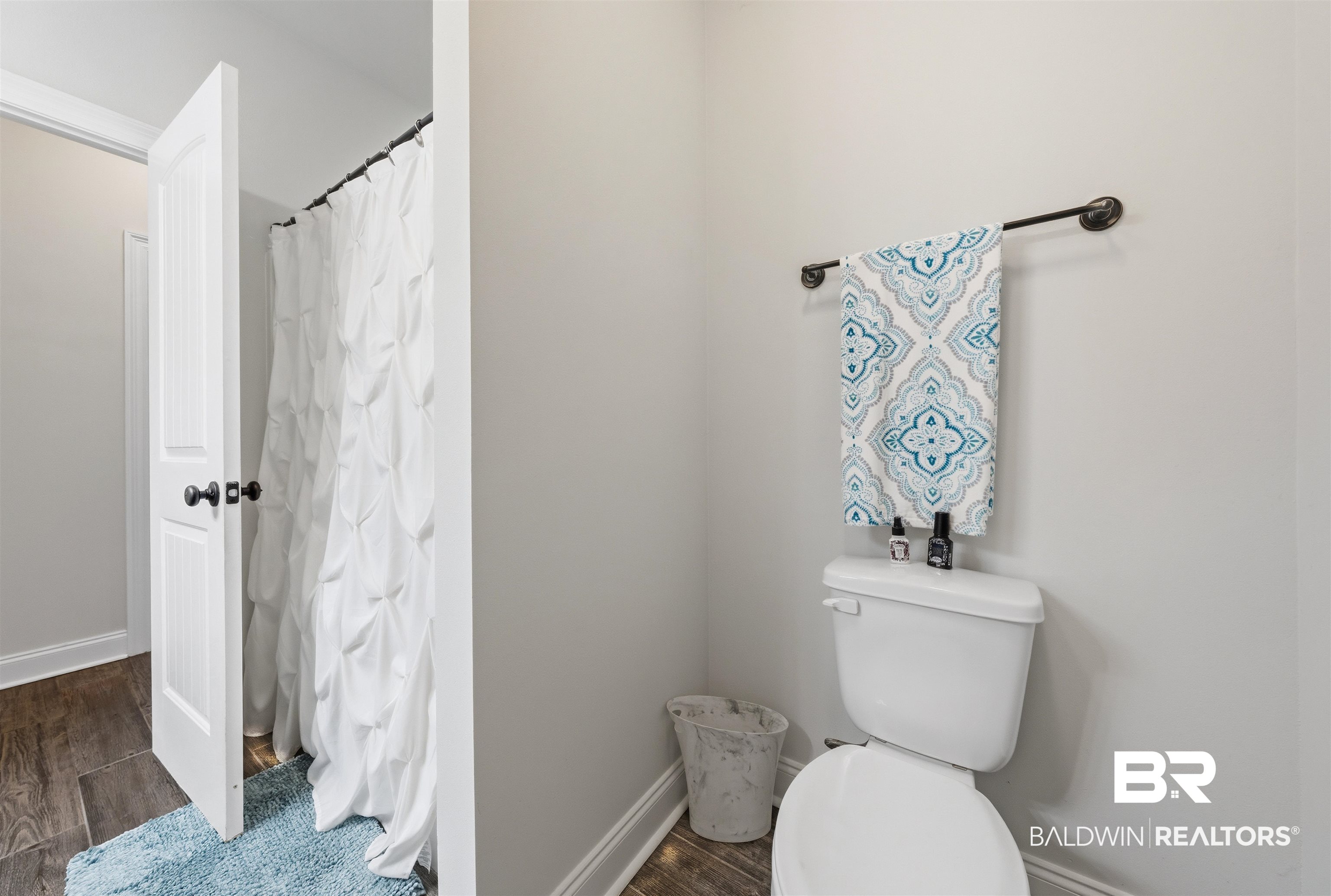 22512 Putter Lane Foley, AL 36535 - Photo 13 of 27 Bathroom with wood tiled floors and a shower with shower curtain