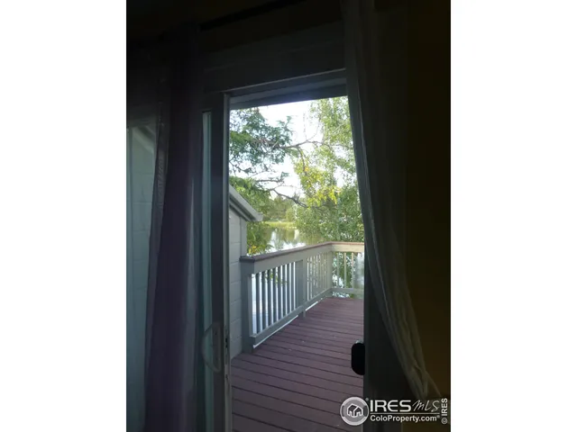 a view of a balcony with wooden floor