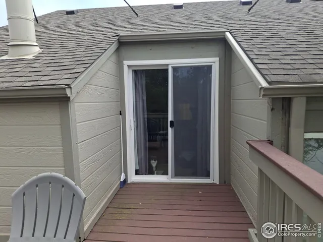 a view of a house with wooden deck