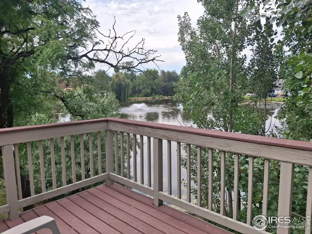 a balcony with wooden floor and fence
