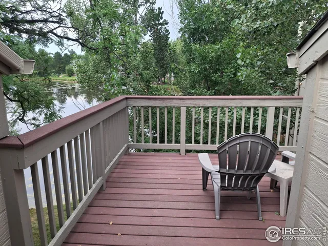 a view of balcony with wooden floor and outdoor seating