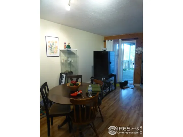 a view of a workspace room with furniture and wooden floor