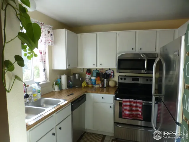 a kitchen with a sink cabinets and stainless steel appliances