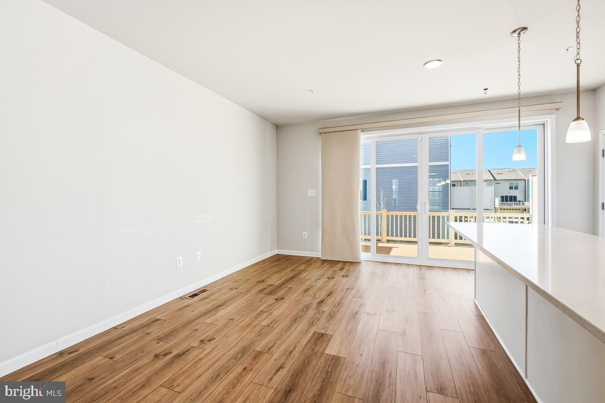 5820 Imperial Drive Frederick, MD 21703 - Photo 13 of 30 a view of an empty room with wooden floor and a window