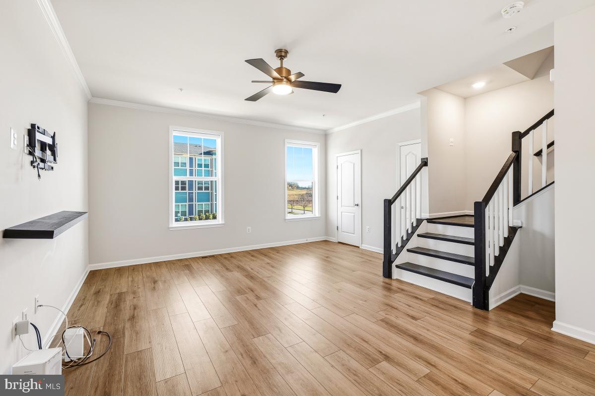 5820 Imperial Drive Frederick, MD 21703 - Photo 15 of 30 a view of an empty room with wooden floor and a window