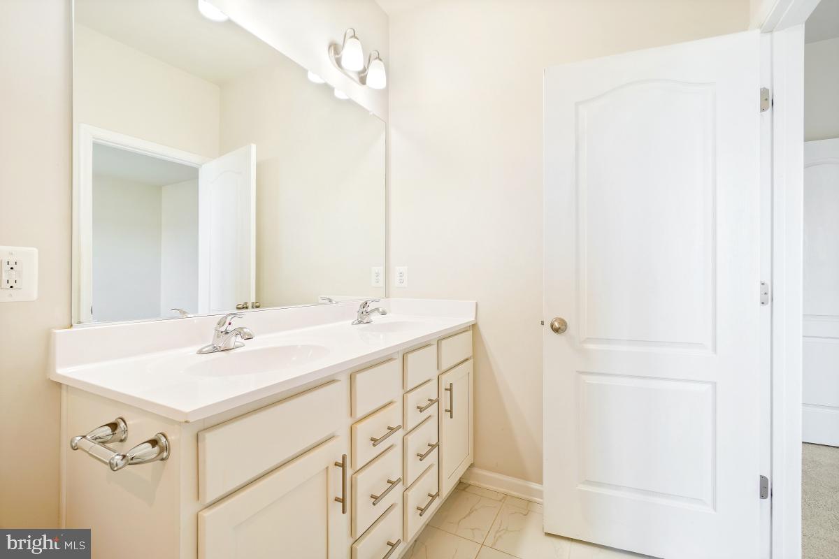 5820 Imperial Drive Frederick, MD 21703 - Photo 26 of 30 a bathroom with a sink and a mirror