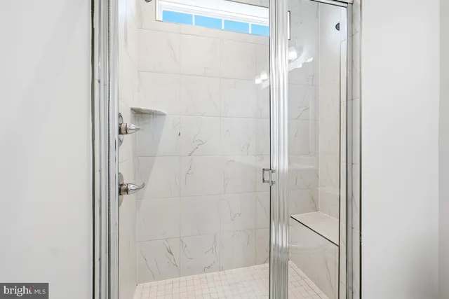 a bathroom with a glass shower door