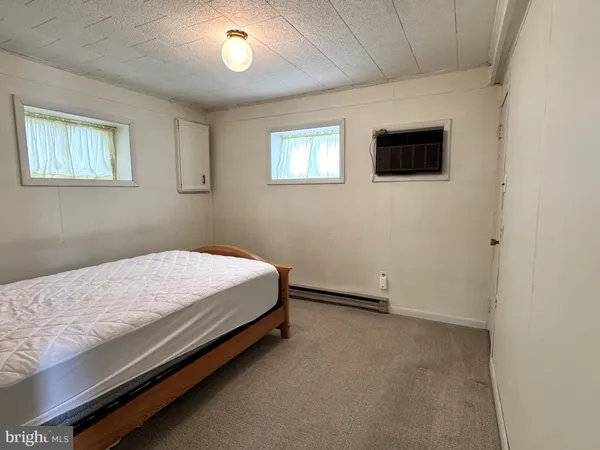 a bed room with a bed and a tv