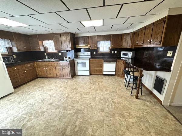 a large kitchen with lots of counter space cabinets and appliances