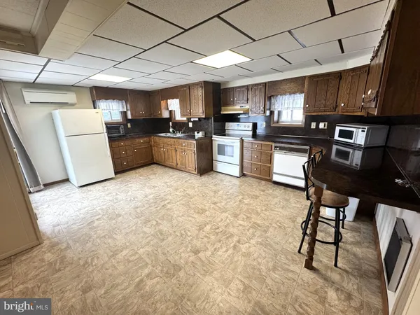 a large kitchen with cabinets and stainless steel appliances