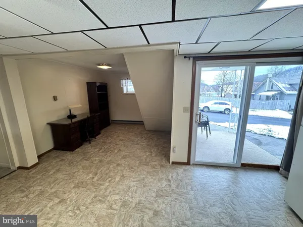 a view of a big room with furniture and windows