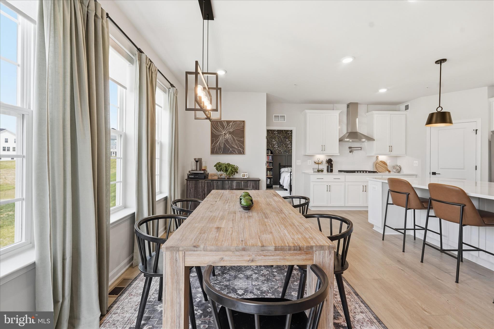 910 Enfield Farm Lane Brunswick, MD 21716 - Photo 23 of 87 a view of a dining room with furniture and wooden floor