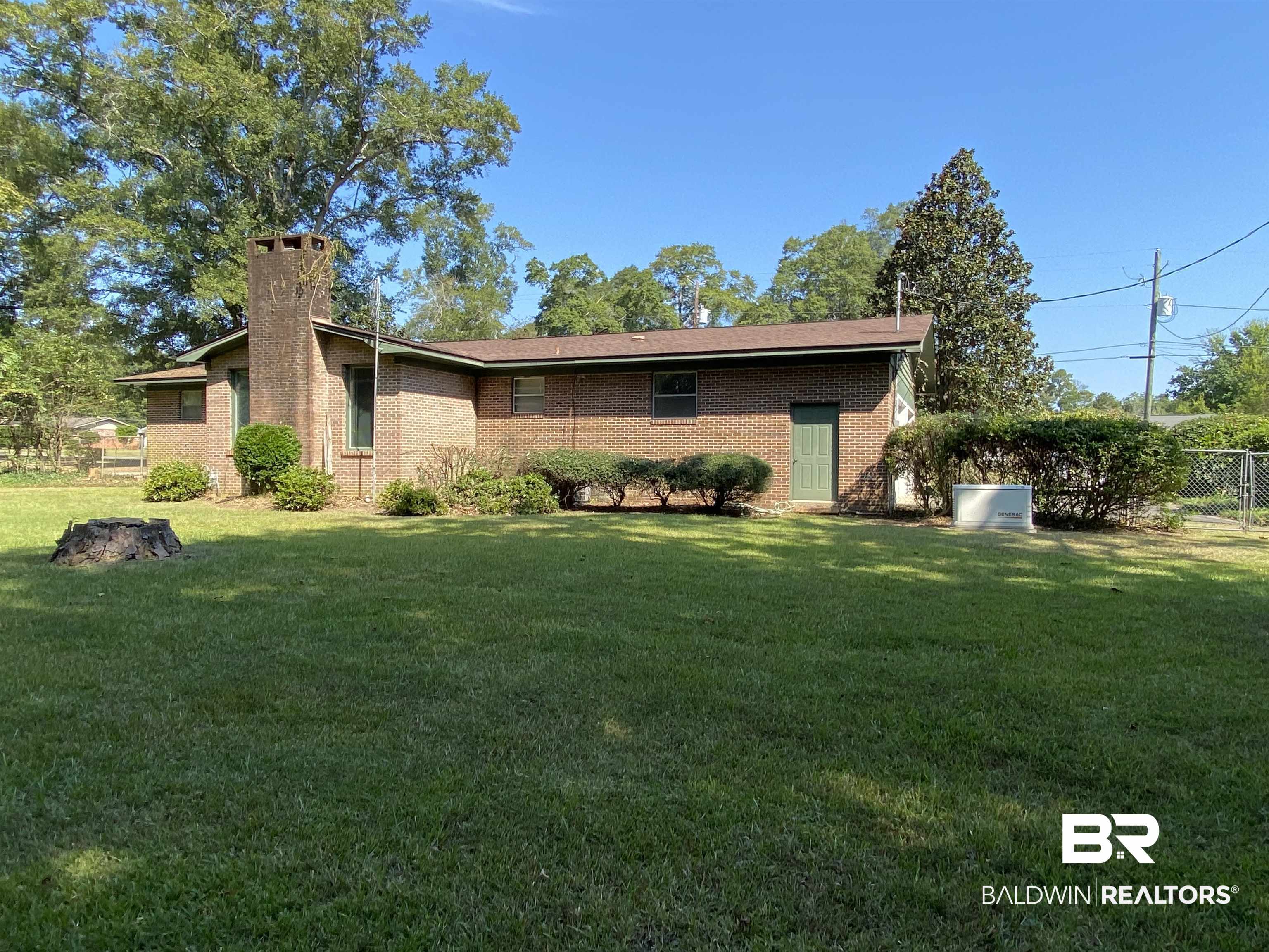 106 Terry Drive Brewton, AL 36426 - Photo 24 of 25 Back of property featuring a chimney and brick siding