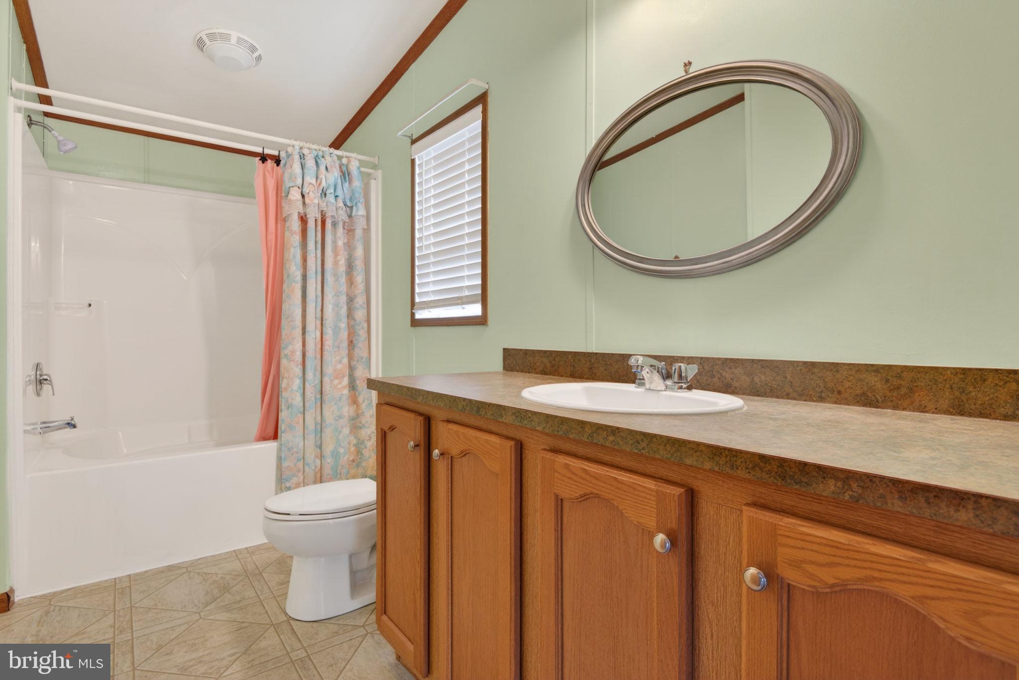 723 Sherry Lane Lancaster, PA 17601 - Photo 15 of 24 a bathroom with a granite countertop toilet sink and mirror