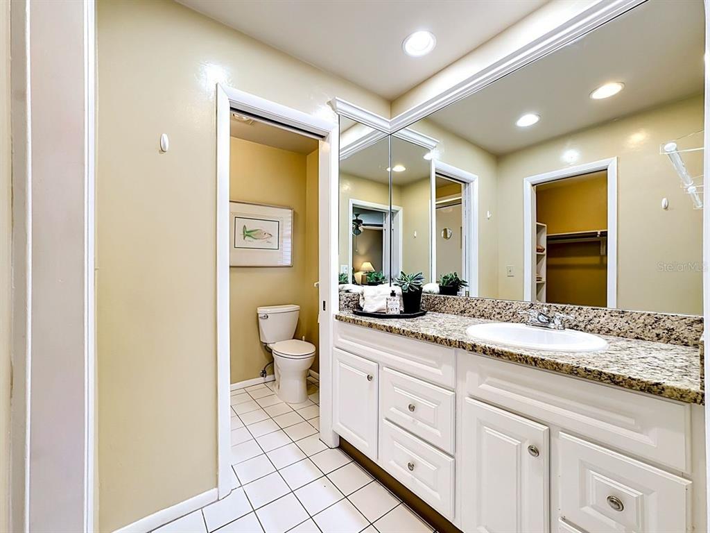 581 Yardarm Lane Longboat Key, FL 34228 - Photo 12 of 30 a spacious bathroom with a granite countertop sink mirror and toilet