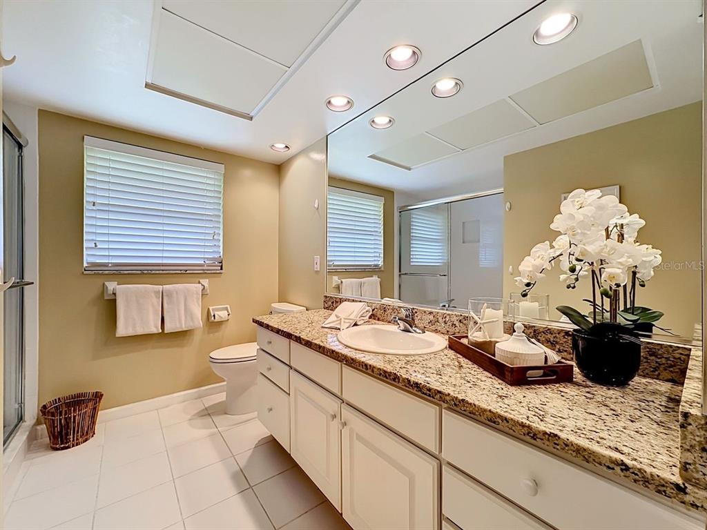 581 Yardarm Lane Longboat Key, FL 34228 - Photo 15 of 30 a bathroom with a double vanity sink and a mirror