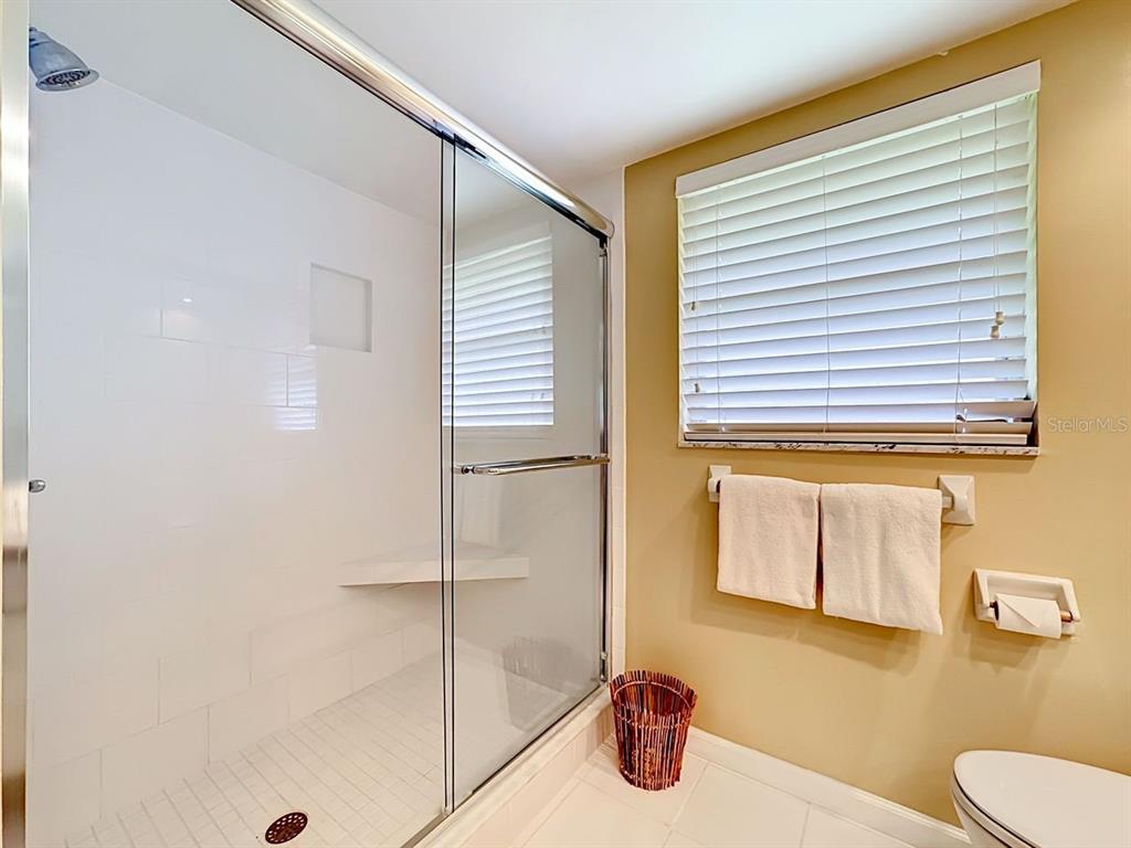 581 Yardarm Lane Longboat Key, FL 34228 - Photo 16 of 30 a bathroom with a sink and a shower