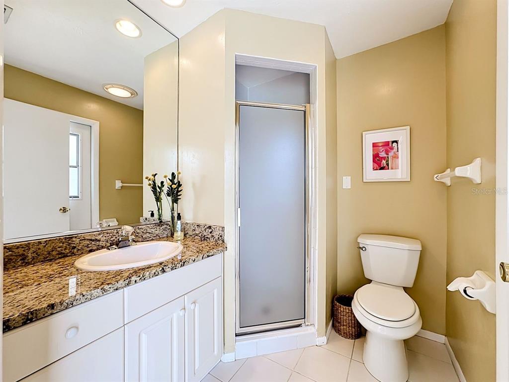 581 Yardarm Lane Longboat Key, FL 34228 - Photo 18 of 30 a bathroom with a granite countertop sink toilet and a mirror