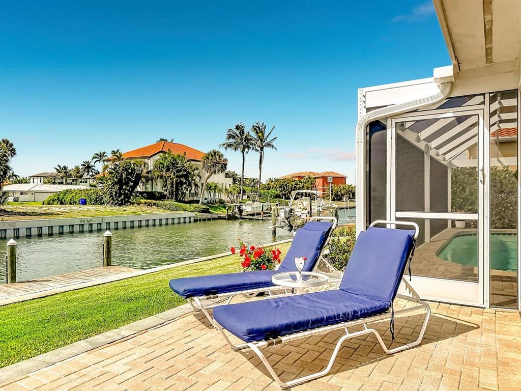 581 Yardarm Lane Longboat Key, FL 34228 - Photo 22 of 30 a view of a lake with couches chairs
