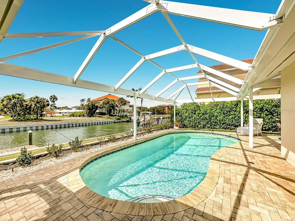 581 Yardarm Lane Longboat Key, FL 34228 - Photo 23 of 30 a view of a swimming pool with a patio