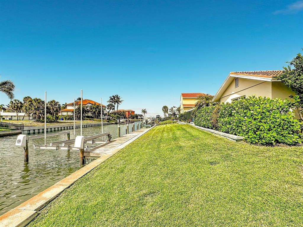 581 Yardarm Lane Longboat Key, FL 34228 - Photo 26 of 30 a view of a swimming pool with a lake view