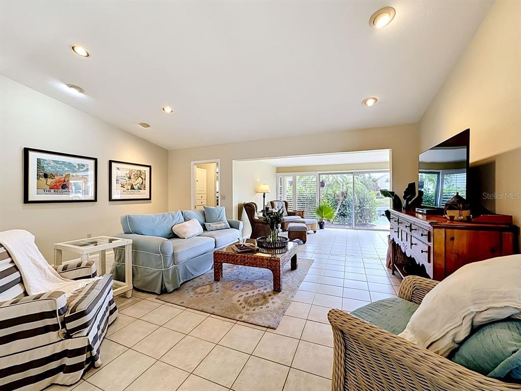 581 Yardarm Lane Longboat Key, FL 34228 - Photo 4 of 30 a living room with furniture and a flat screen tv