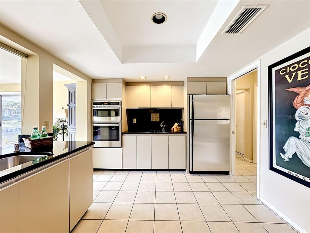 581 Yardarm Lane Longboat Key, FL 34228 - Photo 8 of 30 a kitchen with a refrigerator a stove a sink and a counter top space