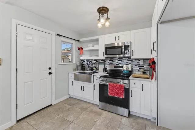 a view of a kitchen area with furniture and wooden floor