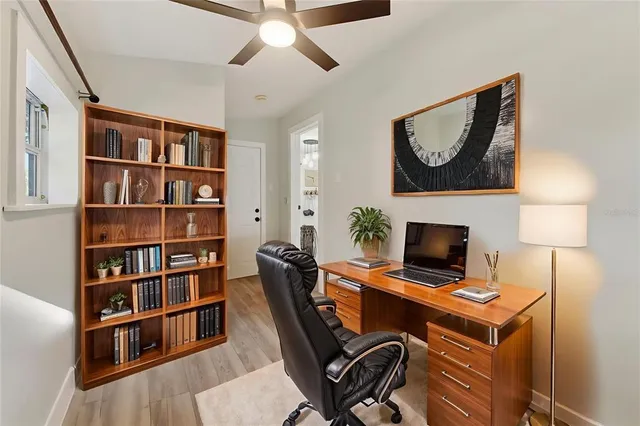 a view of a deck with wooden floor and fence next to a yard