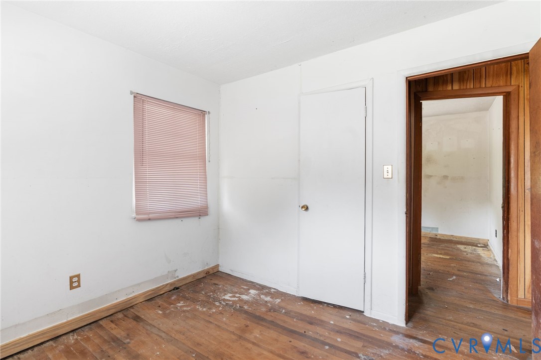 3490 Willow Brook Road Bumpass, VA 23024 - Photo 44 of 47 a view of an empty room with wooden floor and a window