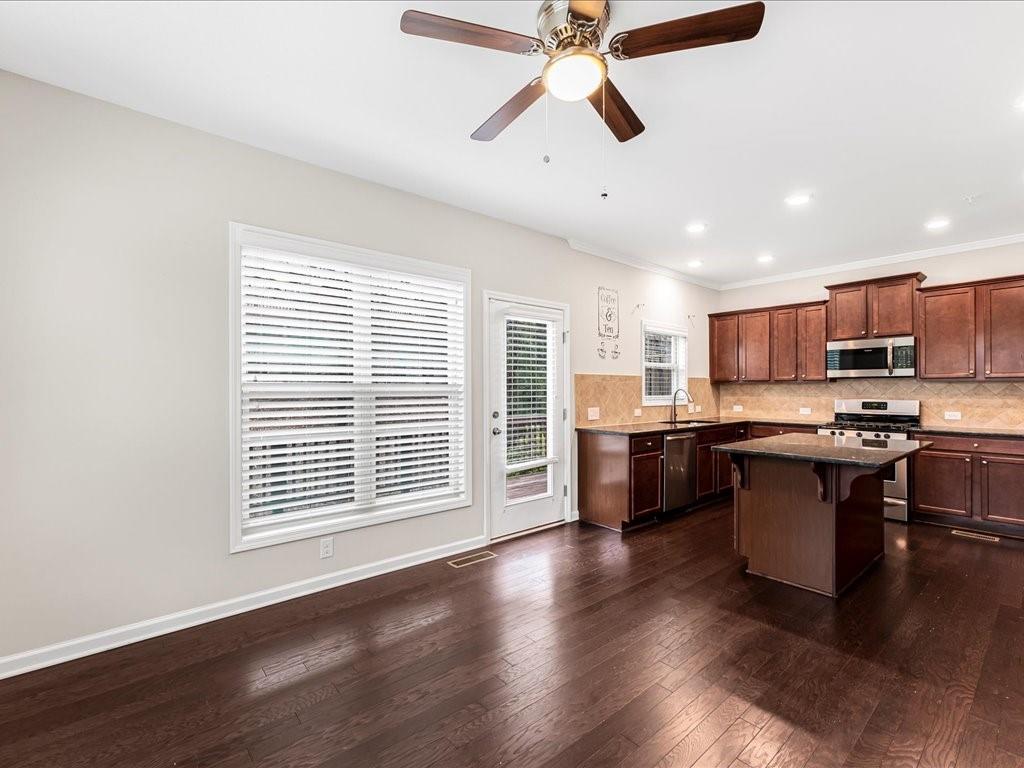 365 Williamson Street Southeast Marietta, GA 30060 - Photo 16 of 28 a kitchen with stainless steel appliances granite countertop a stove cabinets and wooden floor